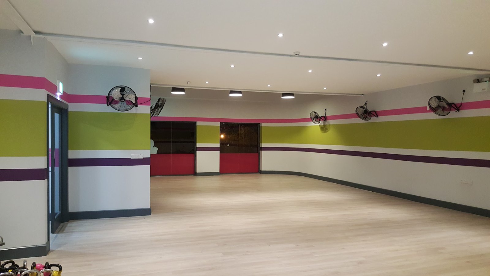 A large hall with ceiling fans and recessed lights