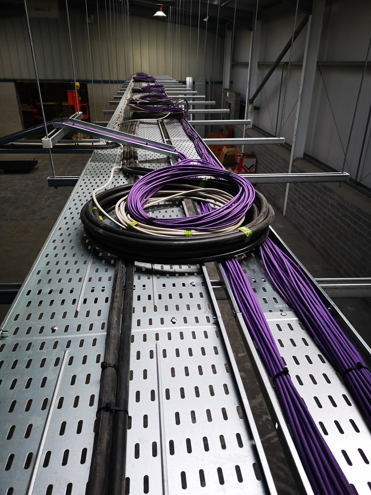 Cable tray with coiled cable on a commercial site