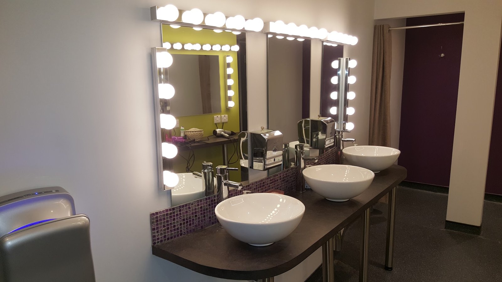 Dressing-room mirrors with bulb surrounds above basins